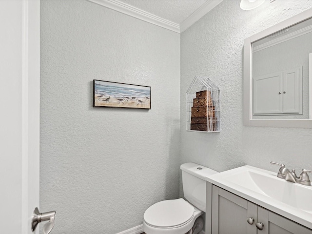 bathroom with toilet, vanity, and crown molding