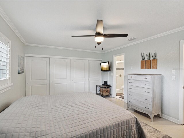 bedroom with ensuite bathroom, ceiling fan, light tile patterned floors, crown molding, and a closet