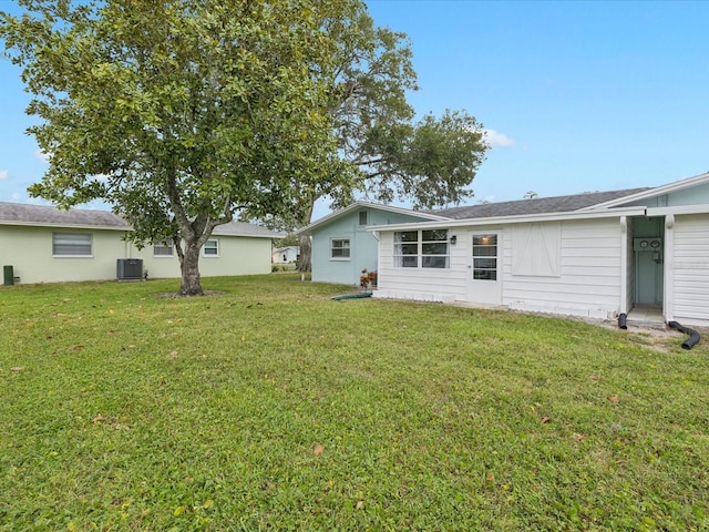 back of property with a yard and cooling unit