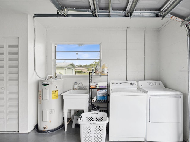 clothes washing area with water heater and washing machine and dryer