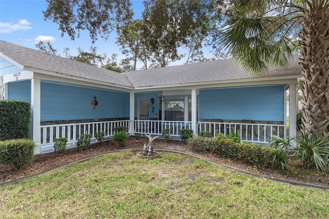 view of front of home with a front yard and covered porch