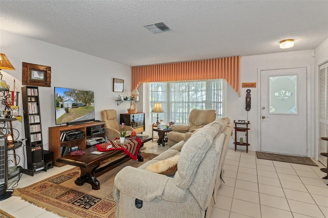 tiled living room with a textured ceiling