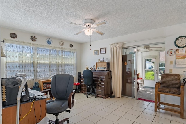 office space featuring a textured ceiling, light tile patterned floors, and ceiling fan