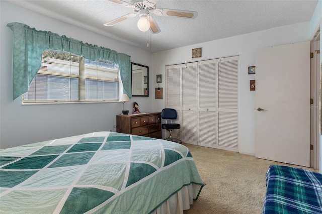 carpeted bedroom featuring a textured ceiling, ceiling fan, and a closet