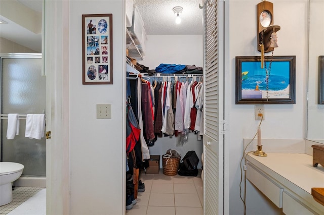 walk in closet featuring light tile patterned flooring