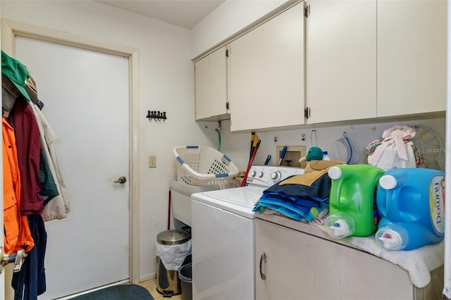 clothes washing area with washing machine and clothes dryer and cabinets