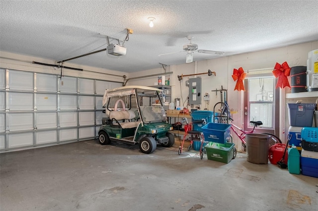 garage with electric panel, a garage door opener, and ceiling fan