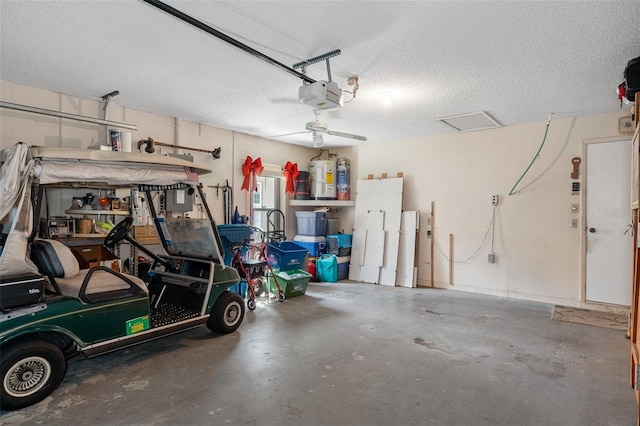 garage with a garage door opener, electric water heater, and ceiling fan