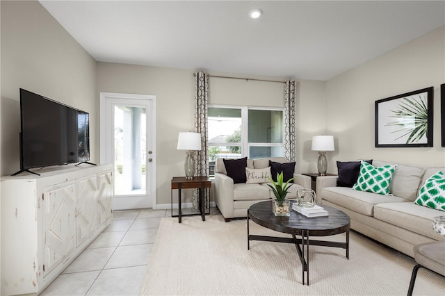 living room with a wealth of natural light and light tile patterned floors