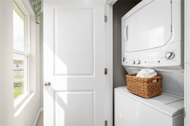 clothes washing area featuring stacked washer and dryer