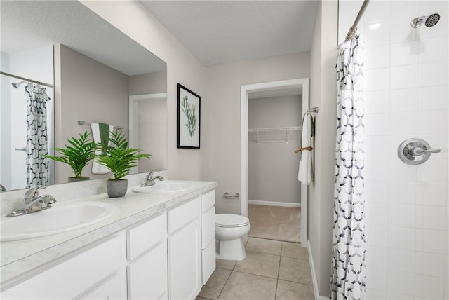 bathroom with a shower with shower curtain, a textured ceiling, vanity, tile patterned floors, and toilet