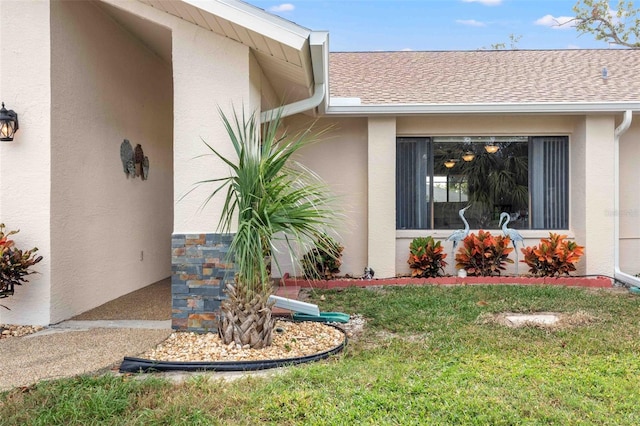 doorway to property with a yard