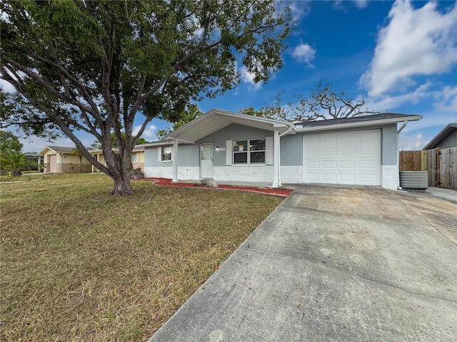 single story home with a garage and a front lawn