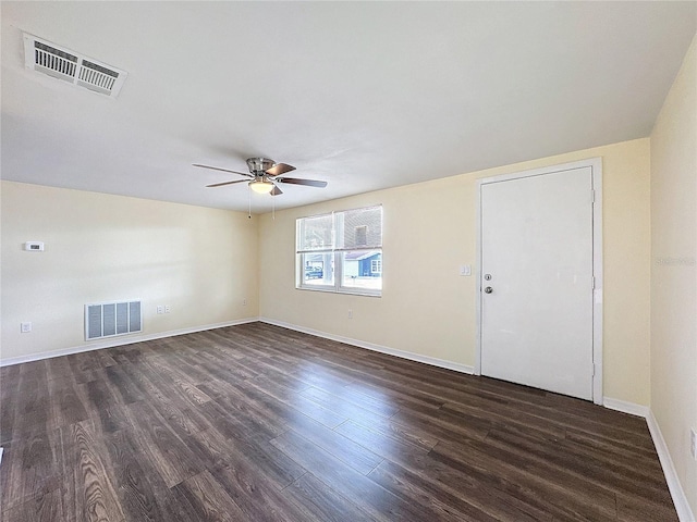 unfurnished room featuring dark wood-type flooring and ceiling fan