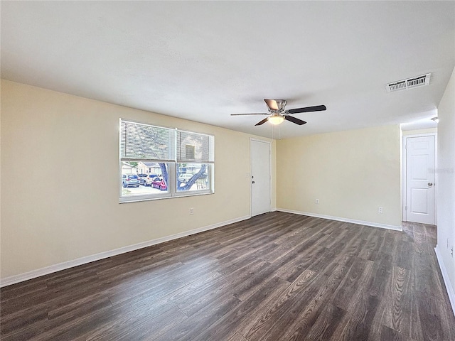 empty room featuring ceiling fan and dark hardwood / wood-style floors