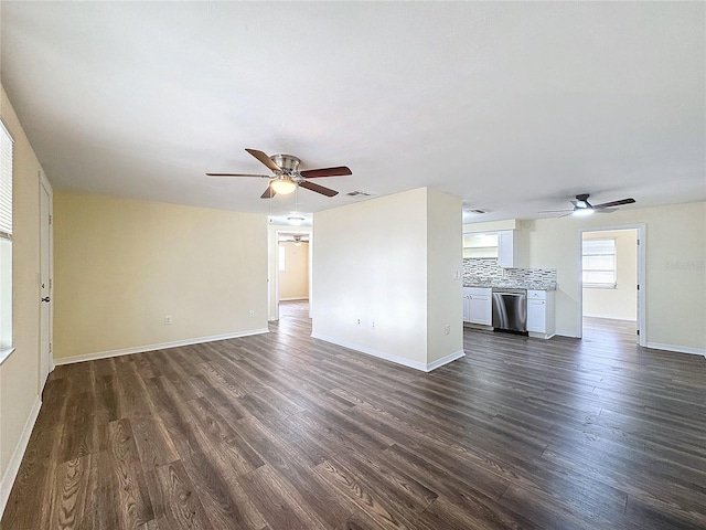 unfurnished living room with dark hardwood / wood-style flooring and ceiling fan