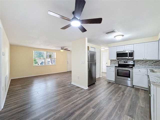 kitchen featuring stainless steel appliances, dark hardwood / wood-style floors, white cabinetry, and decorative backsplash