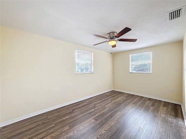 empty room with dark wood-type flooring and ceiling fan