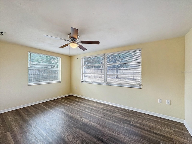 unfurnished room with dark hardwood / wood-style floors and ceiling fan