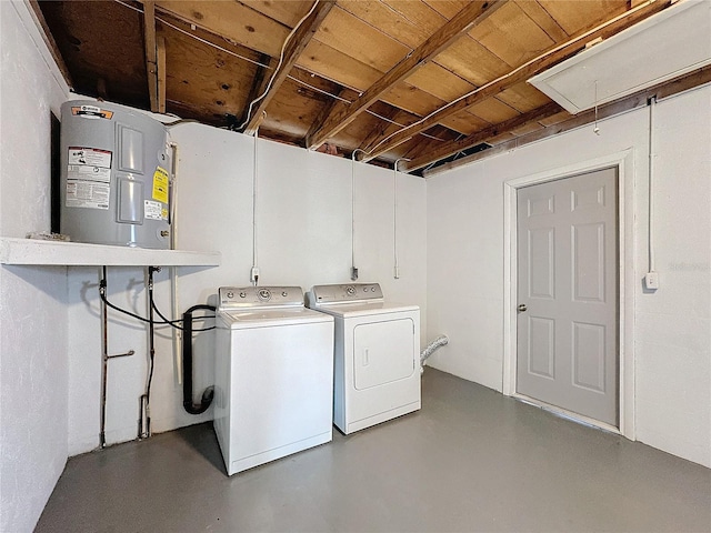 laundry room with water heater and washing machine and dryer