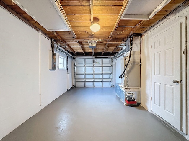 garage featuring electric panel and heating unit