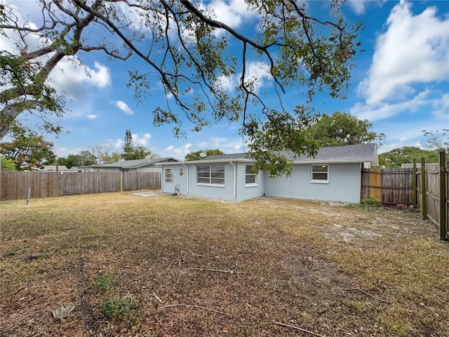 back of property featuring a yard