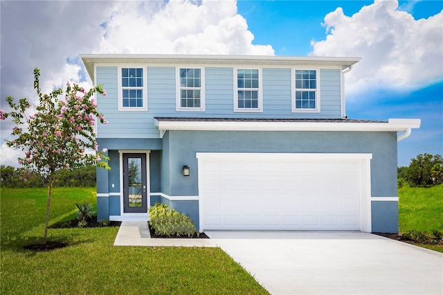 view of property with a front lawn and a garage