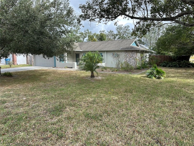 view of front of house with a garage and a front lawn