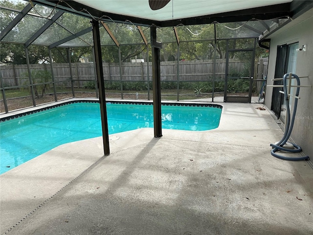 view of swimming pool featuring a patio area and a lanai