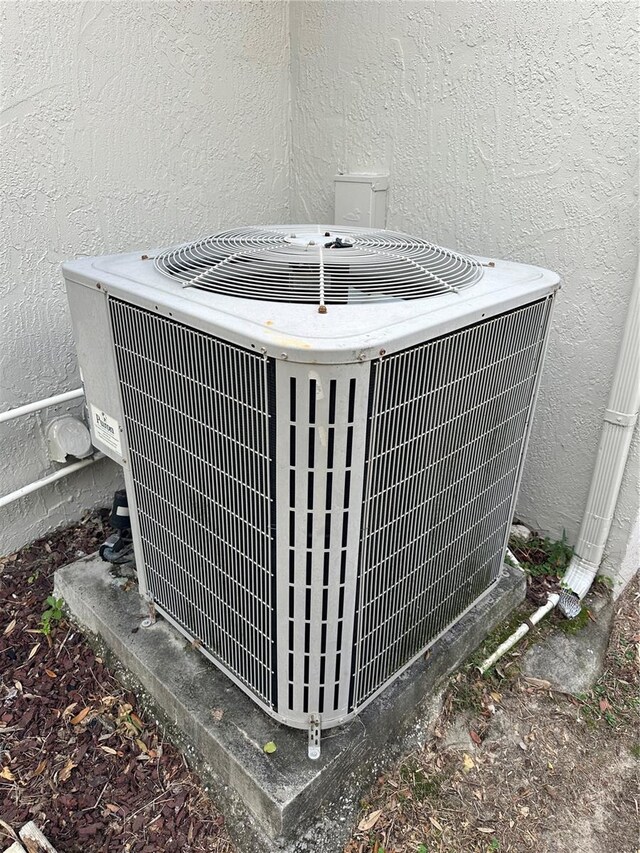 8353 Forest Oaks Blvd, Spring Hill, FL 34606 - exterior view of central AC unit and stucco siding