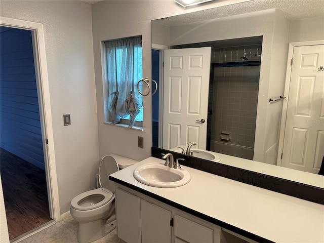 bathroom with vanity, tile patterned flooring, toilet, and a textured ceiling