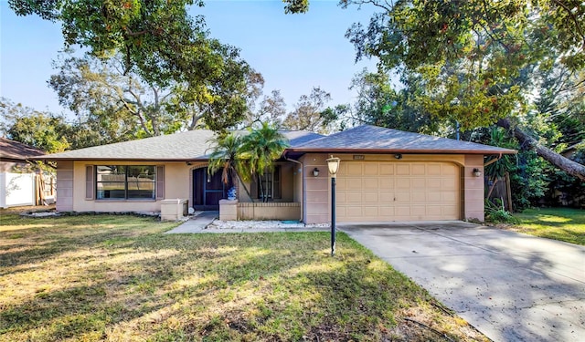 ranch-style house featuring a garage and a front lawn