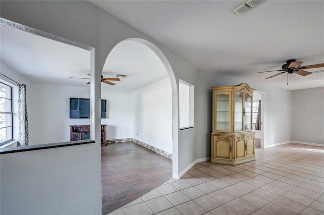 empty room with light hardwood / wood-style floors and ceiling fan