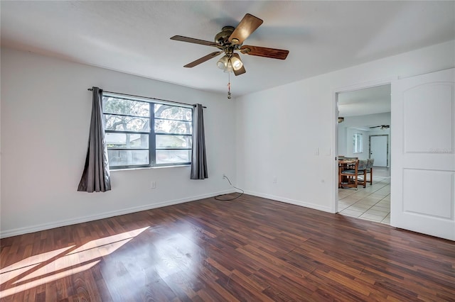 spare room with ceiling fan and wood-type flooring