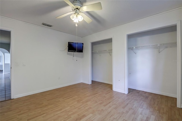 unfurnished bedroom with ceiling fan and light hardwood / wood-style flooring