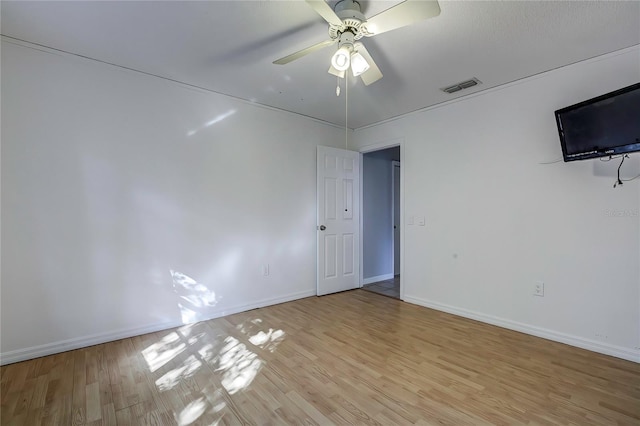 empty room featuring ceiling fan and light hardwood / wood-style floors