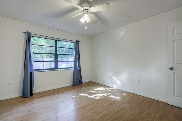 unfurnished room featuring ceiling fan and light hardwood / wood-style floors