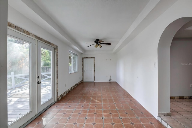 tiled spare room featuring ceiling fan