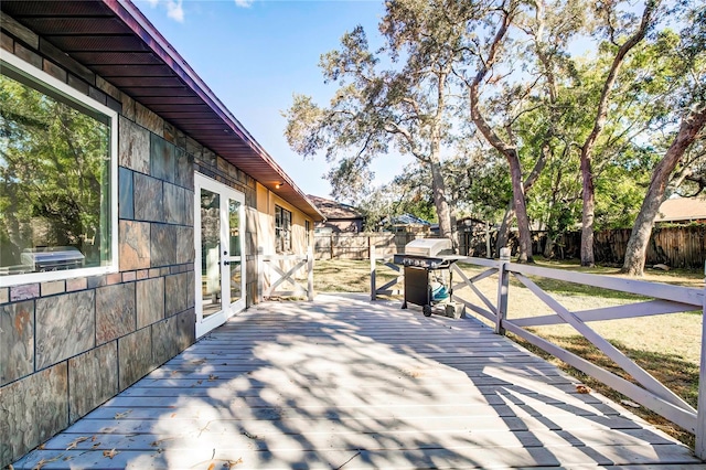 wooden deck with area for grilling and french doors