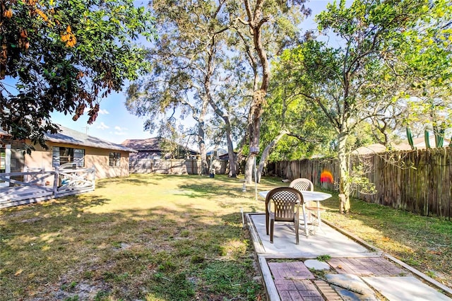 view of yard with a deck and a patio area