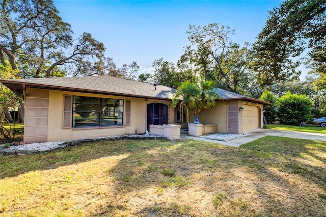 single story home with a garage and a front yard