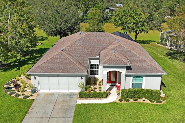 view of front of house with a garage and a front lawn