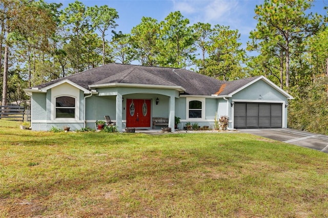 single story home featuring a garage and a front lawn