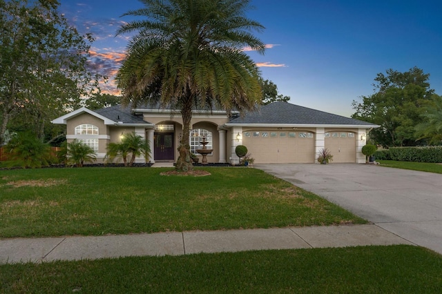 view of front facade with a lawn and a garage