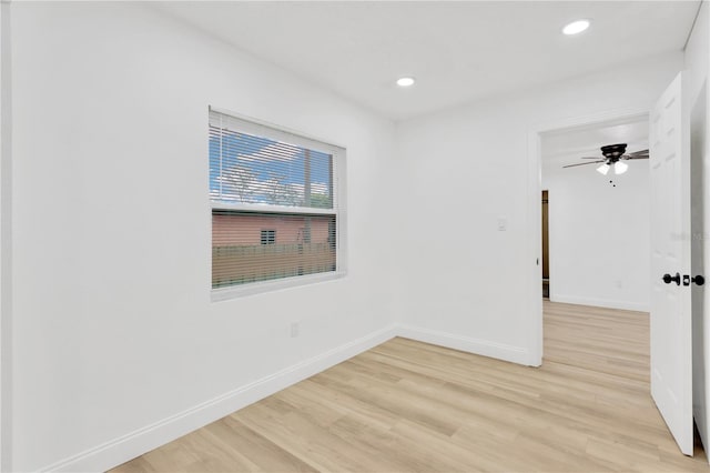 spare room featuring light hardwood / wood-style flooring and ceiling fan