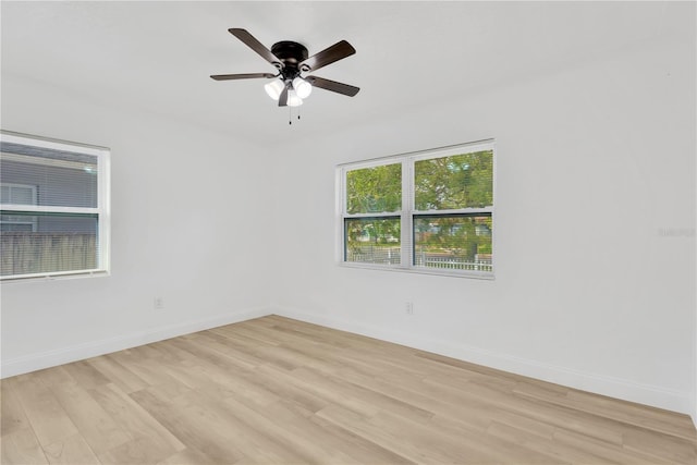 empty room featuring ceiling fan and light hardwood / wood-style flooring