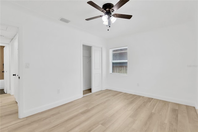 unfurnished bedroom featuring light hardwood / wood-style flooring, ceiling fan, and a closet