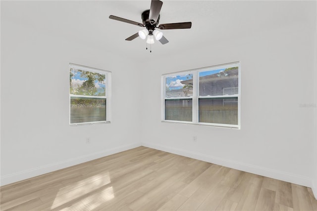 spare room featuring light hardwood / wood-style flooring and ceiling fan