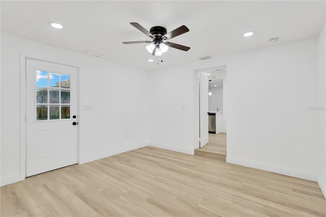 empty room featuring light hardwood / wood-style flooring and ceiling fan