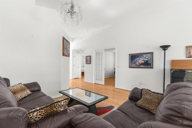 living room featuring a towering ceiling and wood-type flooring